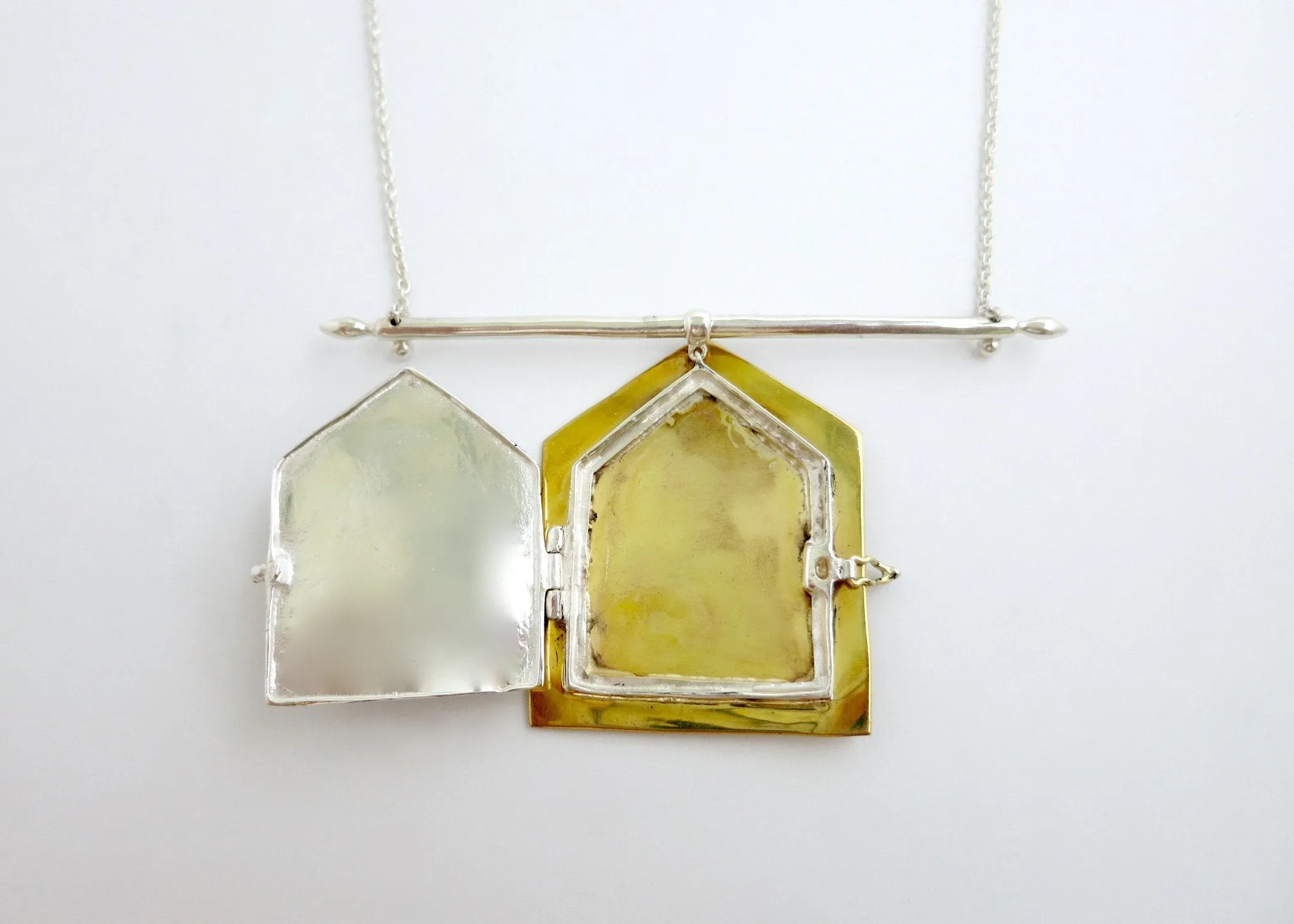 Conversation-starting, bi-metal necklace with a large statement deity amulet