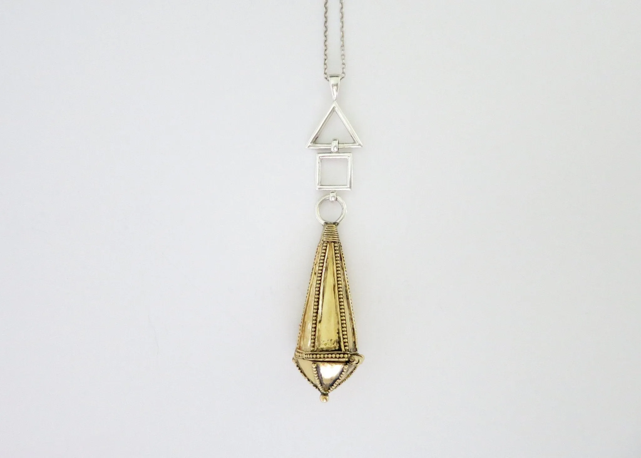Unique, bi-metal, long amuletic pendant, in gold-plated brass and sterling silver