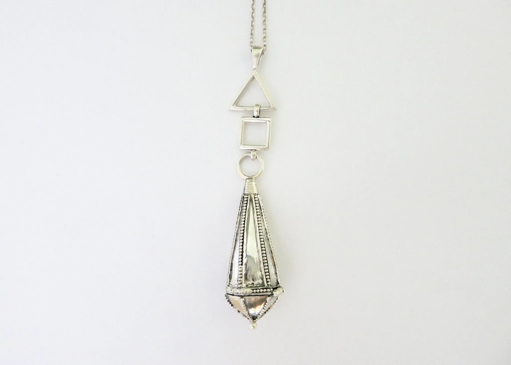 Vintage-chic, long amuletic pendant in sterling silver with fine granulation work